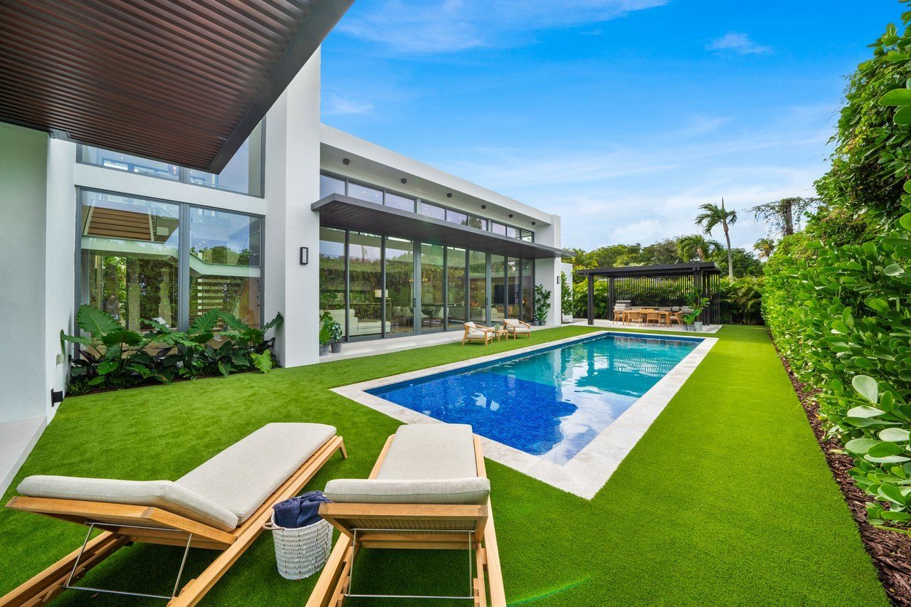 Modern home with glass walls and a pool in Biscayne Park